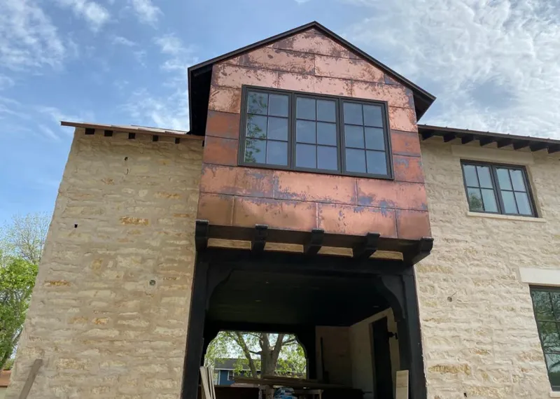Copper metal panel facade on a stone building for Skylight Installation in Orange Beach